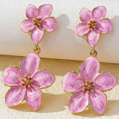 BloomDrop 18K gold plated resin earrings detail shot on ear